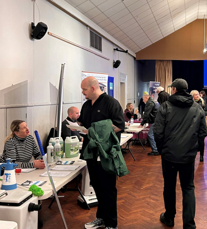 Job seekers talking to employers at the West Devon Employment Fair in January 2024