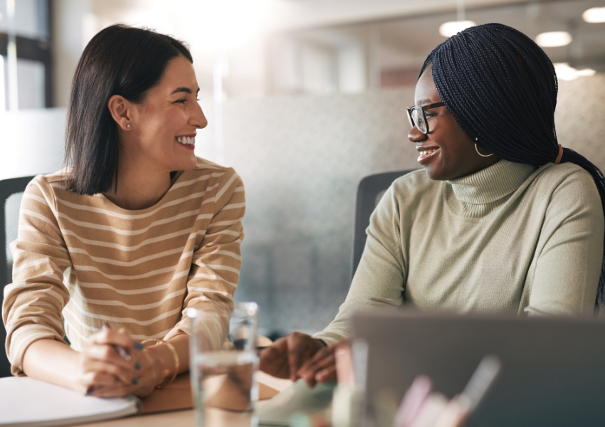 Business owner and employee talking and smiling