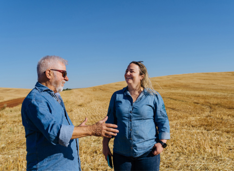 A female farmer speaking with an agricultural advisor in a field