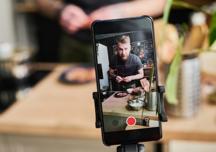 small business owner creating video content with his mobile phone