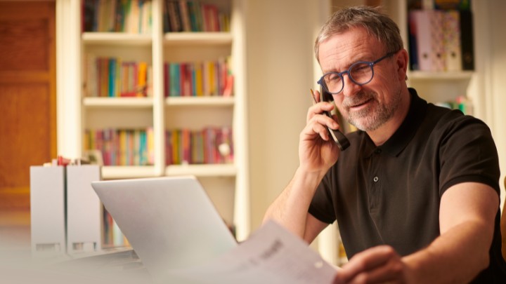 Small business owner on the phone at his desk